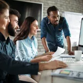 people meeting around a laptop