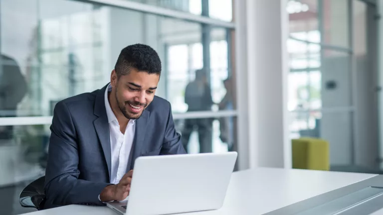 Man at desk making payment