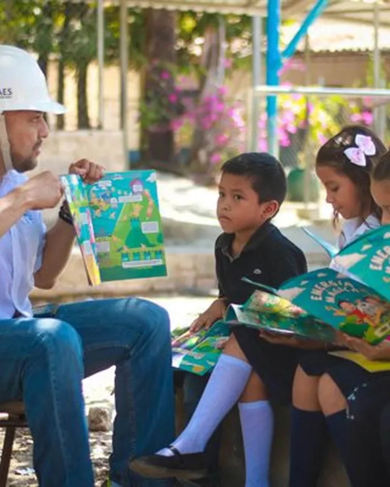 Energy worker reading storybook to children.