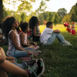 kids sitting on grass