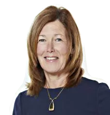 A woman with shoulder-length brown hair, wearing a dark blue top and a pendant necklace, smiles at the camera.