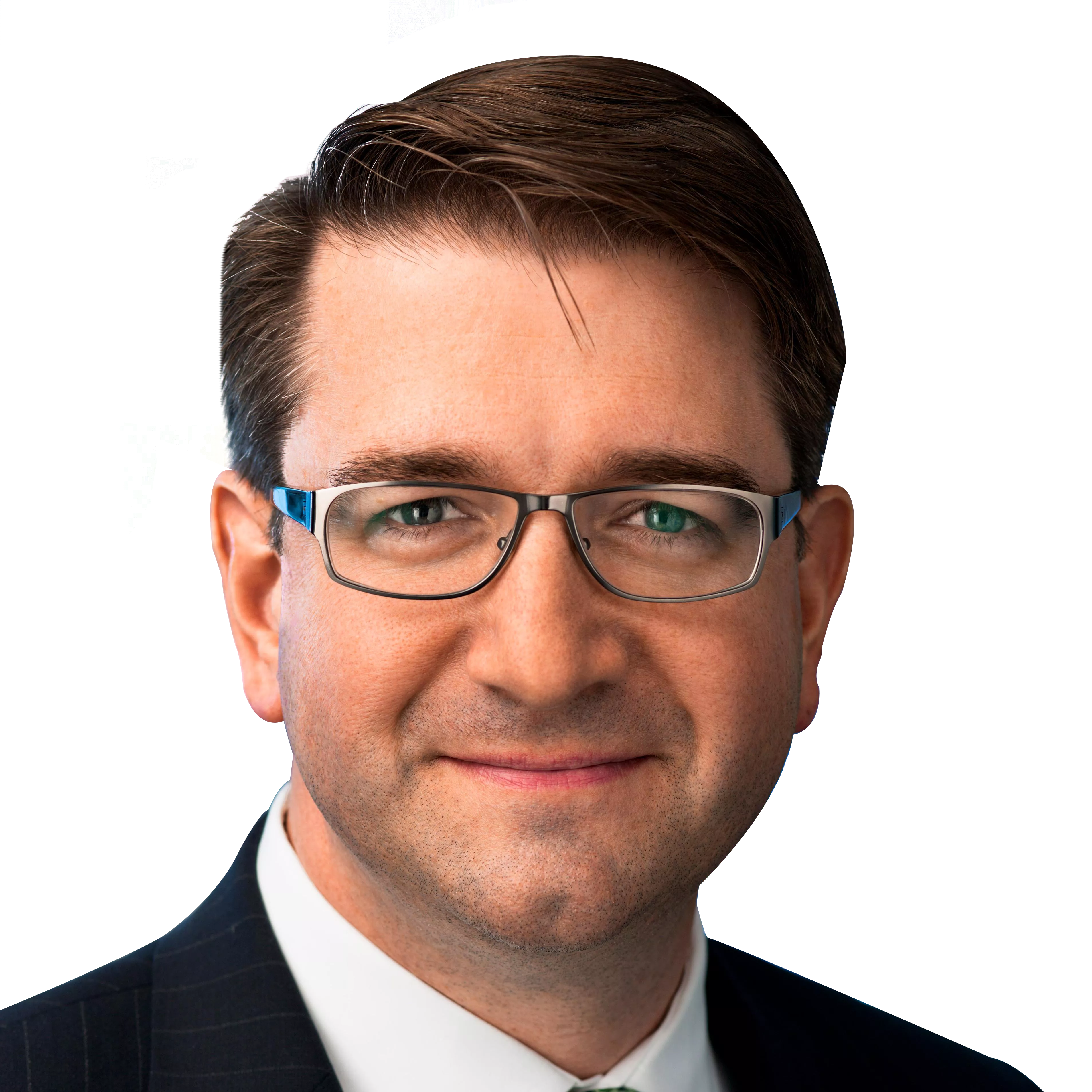 A man with short brown hair and glasses is wearing a dark suit and white shirt, smiling slightly against a black background.